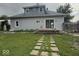 Backyard view of a two-story home featuring a sliding glass door leading to a wooden deck at 1352 S County Road 850 W, Greensburg, IN 47240