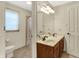 Bright bathroom features double sinks, a full mirror, and shower/tub combination at 1411 N Claridge Way, Carmel, IN 46032