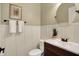 Well-lit bathroom features a modern sink, wall decor, and stylish white wainscoting at 1411 N Claridge Way, Carmel, IN 46032