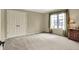 Spacious empty bedroom with neutral paint, a large window, and a double door closet at 1411 N Claridge Way, Carmel, IN 46032
