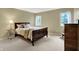 Bedroom with dark wood furnishings and two windows allowing natural light at 1411 N Claridge Way, Carmel, IN 46032