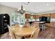 Open-concept dining room leading to a kitchen and living area with beautiful hardwood floors at 1411 N Claridge Way, Carmel, IN 46032