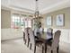 Stylish dining area with a large wood table, upholstered chairs, and a modern light fixture at 1411 N Claridge Way, Carmel, IN 46032