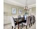 Formal dining room with wainscoting, modern chandelier, and seating for six is great for entertaining at 1411 N Claridge Way, Carmel, IN 46032