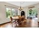 Bright dining room featuring hardwood floors, a chandelier, and large windows with a view to the backyard at 1411 N Claridge Way, Carmel, IN 46032