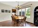 Dining room boasts hardwood floors, a chandelier, and a large window overlooking the green yard at 1411 N Claridge Way, Carmel, IN 46032
