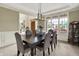 Elegant dining room with a large table, upholstered chairs, and ample natural light at 1411 N Claridge Way, Carmel, IN 46032