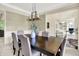 Formal dining room boasts elegant chandelier and leads to other rooms in the house at 1411 N Claridge Way, Carmel, IN 46032