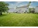 Spacious backyard featuring a lush green lawn, a concrete patio, and mature trees at 16095 Tenor Way, Noblesville, IN 46060