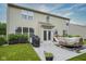 A home backyard with a concrete patio, covered grill, slide and a lush green lawn at 16095 Tenor Way, Noblesville, IN 46060