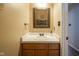 Bathroom vanity featuring a marble countertop and an elegant framed mirror with accent lighting at 16095 Tenor Way, Noblesville, IN 46060