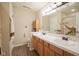 Bright bathroom featuring a double sink vanity with a marble countertop and wooden cabinetry at 16095 Tenor Way, Noblesville, IN 46060