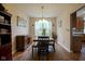 Bright dining room with a stylish chandelier and a view into the kitchen area at 16095 Tenor Way, Noblesville, IN 46060