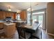 Dining area adjacent to a kitchen, featuring wood flooring and a dining table with seating at 16095 Tenor Way, Noblesville, IN 46060