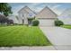 Charming two-story home featuring a brick facade, lush lawn, and attached two-car garage at 16095 Tenor Way, Noblesville, IN 46060