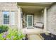 Inviting front porch with a comfortable bench, decorative flowers, and a 'Welcome' door sign at 16095 Tenor Way, Noblesville, IN 46060