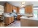 Well-lit kitchen with stainless steel appliances, wooden cabinets, and a center island with marble countertop at 16095 Tenor Way, Noblesville, IN 46060