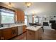 Open-concept kitchen with stainless steel appliances, marble countertops, and a seamless view into the living area at 16095 Tenor Way, Noblesville, IN 46060
