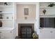 Cozy living room featuring a fireplace, built-in shelving, and neutral paint at 16095 Tenor Way, Noblesville, IN 46060