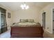 Main bedroom with a chandelier, peaked ceiling, and a bed dressed with a plaid bed set at 16095 Tenor Way, Noblesville, IN 46060
