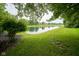 Scenic pond view surrounded by lush greenery and mature trees at 16095 Tenor Way, Noblesville, IN 46060