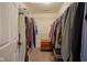 Spacious walk-in closet with white walls, neutral carpet, and clothing racks filled with various garments at 16095 Tenor Way, Noblesville, IN 46060