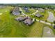 An aerial view of a residential neighborhood showcases lush lawns, ponds, and well-maintained homes at 16548 Grand Cypress Dr, Noblesville, IN 46060
