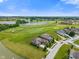 Expansive aerial view showcasing the property within a beautiful golf course community with serene lakes at 16548 Grand Cypress Dr, Noblesville, IN 46060
