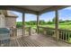 Cozy back deck with a stunning view of the lush green lawn, pond, and surrounding trees at 16548 Grand Cypress Dr, Noblesville, IN 46060