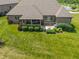 An aerial shot showcases a home's backyard with a well-maintained lawn, patio, and green shrubbery at 16548 Grand Cypress Dr, Noblesville, IN 46060