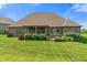 Expansive backyard with lush greenery, a covered patio, and beautiful landscaping for outdoor enjoyment at 16548 Grand Cypress Dr, Noblesville, IN 46060