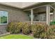 Charming covered patio with brick detailing, nestled in a meticulously landscaped backyard at 16548 Grand Cypress Dr, Noblesville, IN 46060