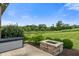 Manicured backyard features a stone fire pit and picturesque pond, perfect for outdoor enjoyment at 16548 Grand Cypress Dr, Noblesville, IN 46060