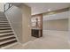 Finished basement with stairs and a wet bar with dark cabinets at 16548 Grand Cypress Dr, Noblesville, IN 46060