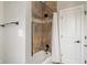 Bathroom with tiled shower, dark hardware, and a white shower curtain at 16548 Grand Cypress Dr, Noblesville, IN 46060