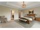 Staged bedroom with neutral colors, a large bed, and ensuite bathroom access at 16548 Grand Cypress Dr, Noblesville, IN 46060