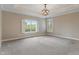 Spacious bedroom with plush carpeting, tray ceiling and abundant natural light from large windows at 16548 Grand Cypress Dr, Noblesville, IN 46060