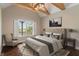 Staged bedroom showcasing wood floors, a vaulted ceiling, and bright windows at 16548 Grand Cypress Dr, Noblesville, IN 46060