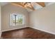 Bedroom featuring a vaulted ceiling with exposed beams and a large window at 16548 Grand Cypress Dr, Noblesville, IN 46060