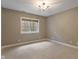 This bedroom has carpet and a double-hung window at 16548 Grand Cypress Dr, Noblesville, IN 46060