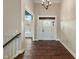 A bright foyer with hardwood floors leads to adjacent rooms and is illuminated by an elegant chandelier at 16548 Grand Cypress Dr, Noblesville, IN 46060