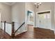 Foyer view featuring hardwood floors, a staircase, and a view into other rooms at 16548 Grand Cypress Dr, Noblesville, IN 46060