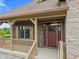 A welcoming front entrance features stone accents, a red front door, and a covered porch at 16548 Grand Cypress Dr, Noblesville, IN 46060
