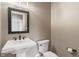 Half bathroom with pedestal sink, framed mirror, and toilet at 16548 Grand Cypress Dr, Noblesville, IN 46060