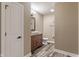 Charming half bathroom with a vessel sink, wood vanity, and decorative mirror on a unique floor at 16548 Grand Cypress Dr, Noblesville, IN 46060