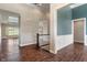 A spacious hallway with hardwood floors, a staircase, and openings to other rooms at 16548 Grand Cypress Dr, Noblesville, IN 46060