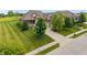 Beautiful home featuring a manicured lawn, mature trees, and an inviting driveway at 16548 Grand Cypress Dr, Noblesville, IN 46060