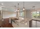 Granite kitchen island with sink and stainless-steel appliances at 16548 Grand Cypress Dr, Noblesville, IN 46060