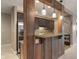 A beautifully equipped kitchenette features granite countertops, pendant lighting, and rustic wood accents at 16548 Grand Cypress Dr, Noblesville, IN 46060