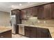 This kitchenette offers stainless steel appliances, granite counters, and dark wood cabinetry at 16548 Grand Cypress Dr, Noblesville, IN 46060